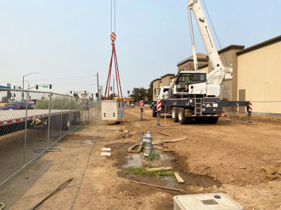 Image of our crane lifting an underground 
						vault for 3-Phase 480V power.